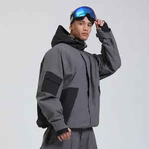 Waterproof men's ski jacket in dark grey and black with matching pants and blue goggles