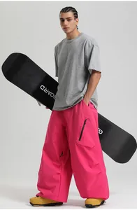 Outdoor sports apparel featuring baggy rose-pink waterproof ski pants and gray T-shirt