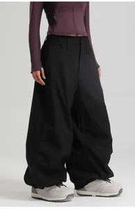 Detail of waterproof black ski pants showing windproof fabric and baggy cargo fit