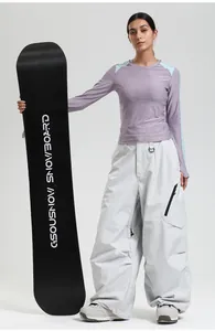 Detail view of white waterproof ski pants with functional black zipper pockets and waist hook
