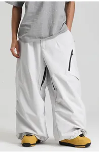 Detail view of white baggy ski pants with waterproof fabric and utility zipper pockets