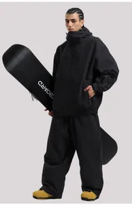Close-up of waterproof black hooded ski jacket and pants set with windproof collar detail