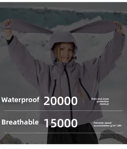 Waterproof purple kids ski jacket with rabbit ears on a snowy mountain background