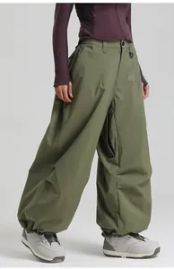 Detail of olive green waterproof ski pants featuring elastic waist and zip pockets
