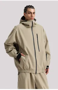 Close-up of khaki waterproof jacket with black zippers and adjustable velcro cuffs