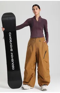 Close-up of baggy mustard yellow ski pants with functional black zipper side pockets