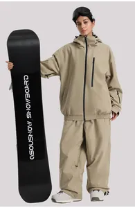 Detail view of khaki waterproof ski jacket and pants set with matching black snowboard