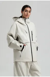Detail view of off-white waterproof ski jacket with hood and multiple black zipper pockets