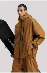 Detail of tan waterproof ski jacket featuring zippered pockets and adjustable velcro cuffs