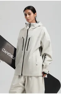 Detail of off-white women's ski jacket featuring waterproof black zippers and hood