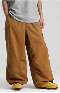 Outdoor waterproof ski pants in tan with side zipper pockets and loose tactical design