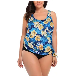 Detail of plus size tankini featuring tropical floral print and side knot on the hem