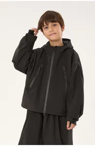 Waterproof zippers and technical fabric detail on black kids professional ski jacket