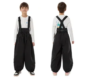 Kids black windproof ski bib pants with adjustable straps and high waist detail