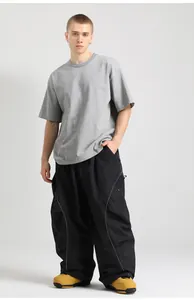 Detailed view of baggy cargo pants with side zipper pockets and loose cotton gray t-shirt