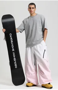 Detail of pink and white gradient loose-fit waterproof ski pants with matching snowboard