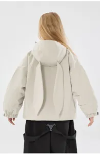 Detail of a beige hooded ski jacket for kids featuring cute rabbit ears on the hood