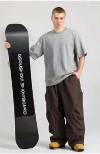 Close-up of loose-fit brown cargo ski pants with tactical pockets and reflective stripes
