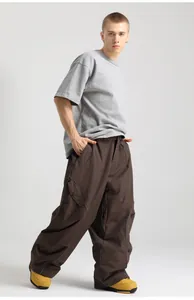 Detail view of cargo pockets and drawstring cuffs on waterproof dark brown ski pants