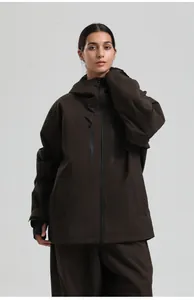 Detail of waterproof zippers and hand guards on a brown pro ski jacket for men and women