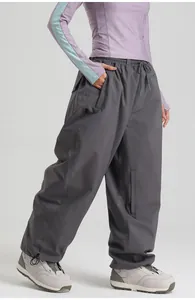 Detail of waterproof ski pants featuring elastic drawstring waist and side zipper pockets