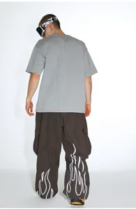 Detailed rear view of brown cargo ski pants featuring white flame pattern at the cuffs