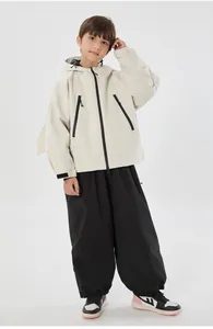 Close-up of children's windproof ski jacket with rabbit ears and matching black cargo pants