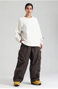 Detail of loose fit brown ski pants featuring reflective stripes and cargo pockets