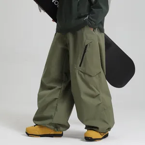 Waterproof olive green ski pants in wide-leg cargo style for outdoor snowboarding sports