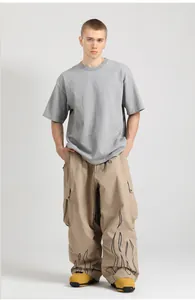 Detail of loose-fit cargo pants featuring black flame print and side utility pockets