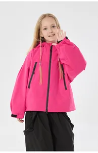 Detail of kids pink windproof ski jacket featuring hood and black zipper pockets