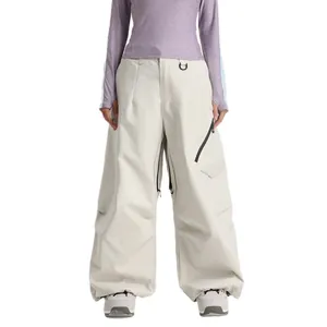 Women's purple outdoor top and loose cream waterproof ski pants with black zippers