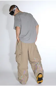 Detail view of khaki ski pants featuring a reflective flame pattern on the back of the leg