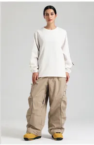 Front view of waterproof white sweatshirt and khaki multi-pocket cargo ski pants