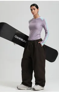 Close-up of women's purple slim-fit thermal top and loose brown windproof ski pants