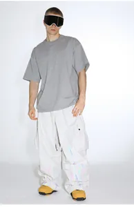 Close-up of baggy white cargo pants with colorful flame patterns and side pockets