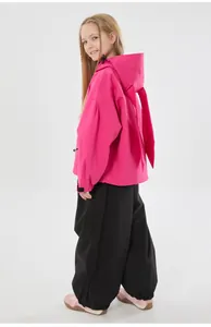 Detail view of pink hooded ski jacket with cute rabbit ears and black waterproof pants