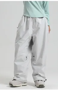 Close-up of waterproof cargo ski pants featuring zipper pockets and waist drawstring