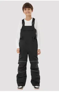 Detail of children's waterproof ski overalls featuring adjustable straps and reflective stripes
