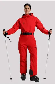 Detail of red one-piece ski suit featuring waterproof fabric and hooded design with belt
