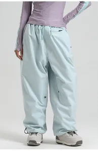 Detail of waterproof ski pants featuring elastic drawstring waist and secure zipper pockets
