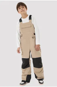 Close-up of kids waterproof ski bibs with reinforced knees and reflective safety strips
