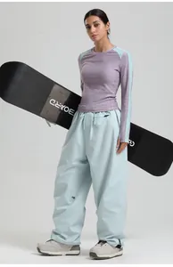 Detail view of purple and light blue ski suit with windproof pants and outdoor gear