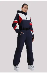 Detailed view of women's one-piece ski suit with tricolor design and waterproof fabric