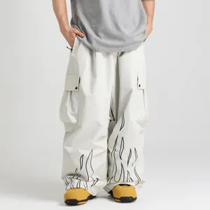 Waterproof white ski pants for men featuring black flame prints and a loose baggy fit