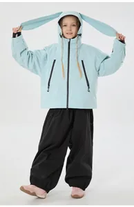 Detail of light blue ski jacket with rabbit ears and black pants for kids