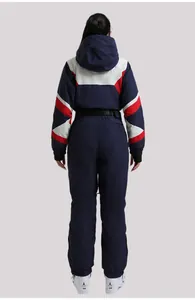 Rear view of women's one-piece ski suit in navy and red with windproof hood and waist belt