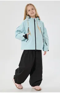 Kids ski suit detail featuring light blue hooded jacket and black windproof pants