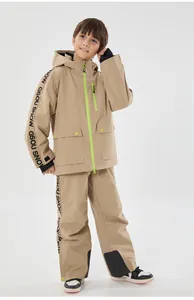 Detail of khaki kids ski suit with neon green accents and waterproof texture