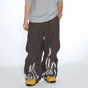 Waterproof reflective ski pants in dark brown with white flame patterns and cargo pockets